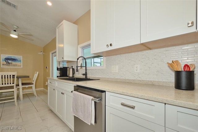 kitchen with a sink, marble finish floor, white cabinetry, and dishwasher