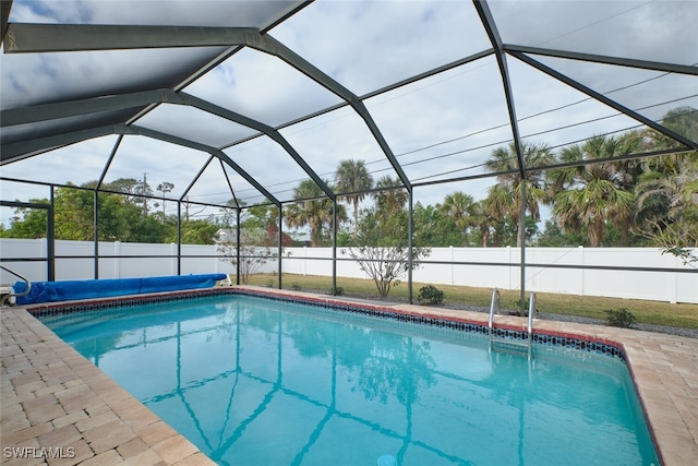 view of swimming pool featuring a fenced in pool, a lanai, a fenced backyard, and a patio