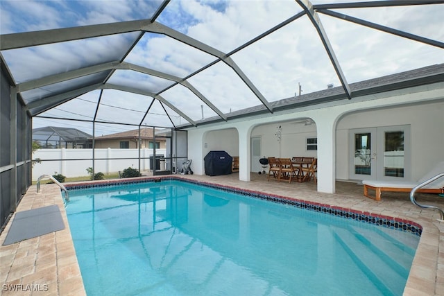 view of swimming pool featuring a fenced in pool, french doors, a patio, and grilling area