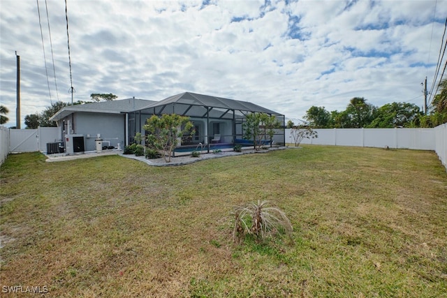 view of yard with a fenced in pool, glass enclosure, a fenced backyard, cooling unit, and a patio area