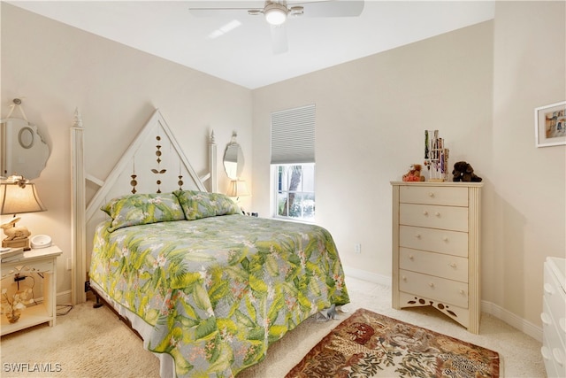 bedroom with a ceiling fan, light carpet, and baseboards