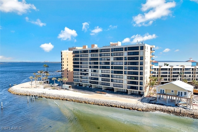 view of building exterior featuring a view of the beach and a water view