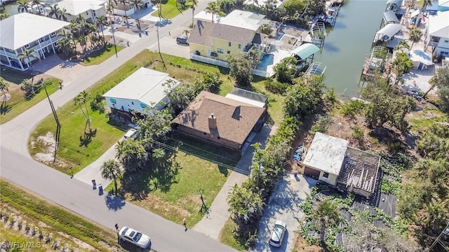 drone / aerial view with a water view and a residential view