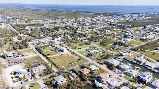 drone / aerial view featuring a water view and a residential view