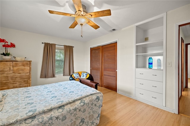 bedroom with a ceiling fan, a closet, visible vents, and light wood-style floors