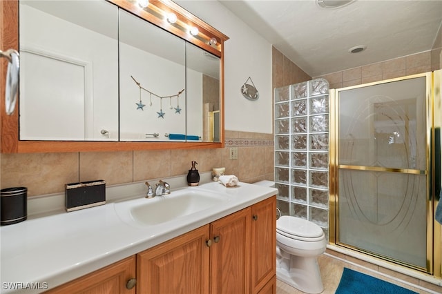 full bath with a shower stall, toilet, tile walls, and vanity