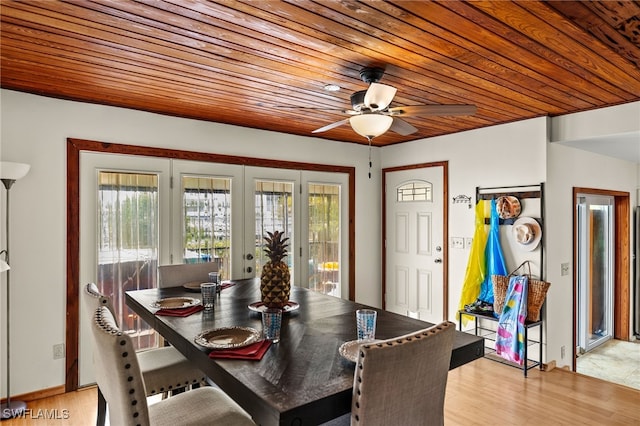 dining space with light wood-style floors, wood ceiling, ceiling fan, and french doors