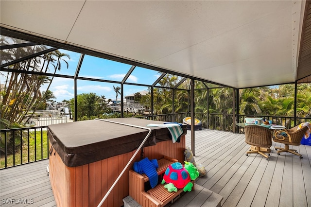 deck featuring a lanai and a hot tub