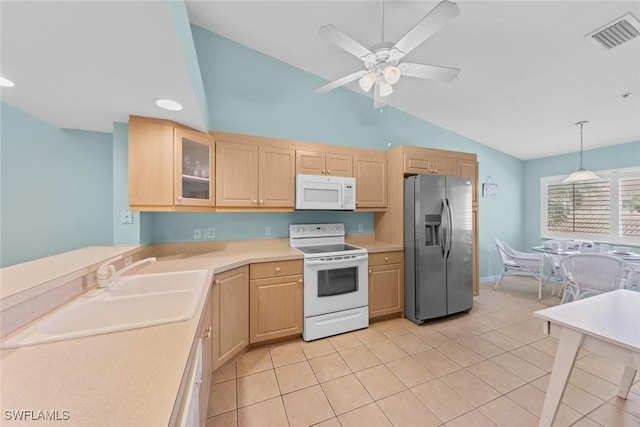 kitchen with decorative light fixtures, light countertops, light brown cabinetry, glass insert cabinets, and white appliances