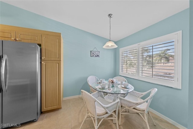 dining room with light tile patterned flooring and baseboards