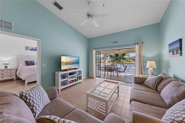 living area with light tile patterned floors, ceiling fan, visible vents, and high vaulted ceiling