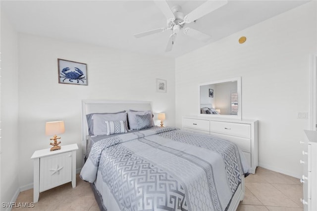 bedroom with ceiling fan, baseboards, and light tile patterned floors