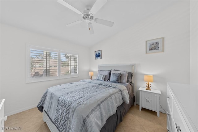 bedroom featuring lofted ceiling, ceiling fan, baseboards, and light tile patterned floors