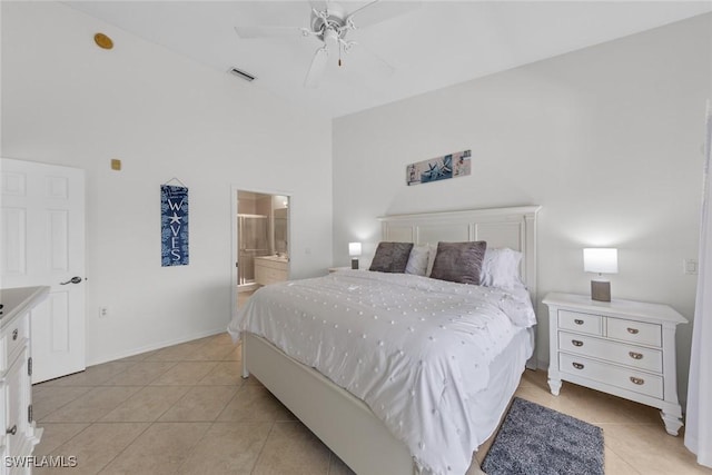 bedroom with visible vents, a ceiling fan, light tile patterned flooring, ensuite bath, and baseboards