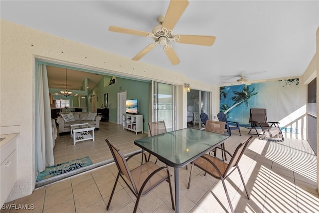 sunroom / solarium with ceiling fan with notable chandelier