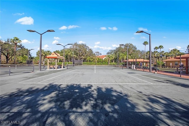 view of tennis court featuring fence