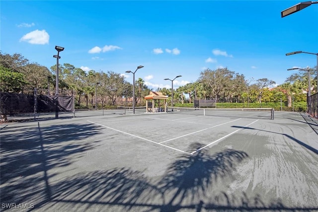 view of tennis court with fence