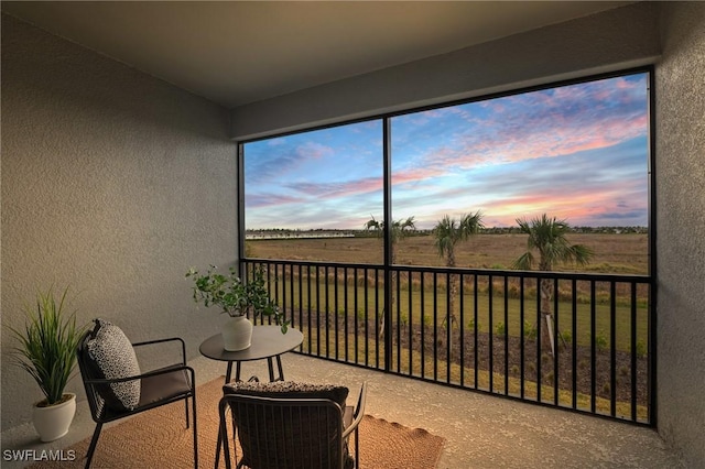 sunroom featuring a rural view