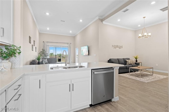 kitchen with dishwasher, light countertops, open floor plan, and a sink