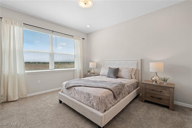 carpeted bedroom with baseboards