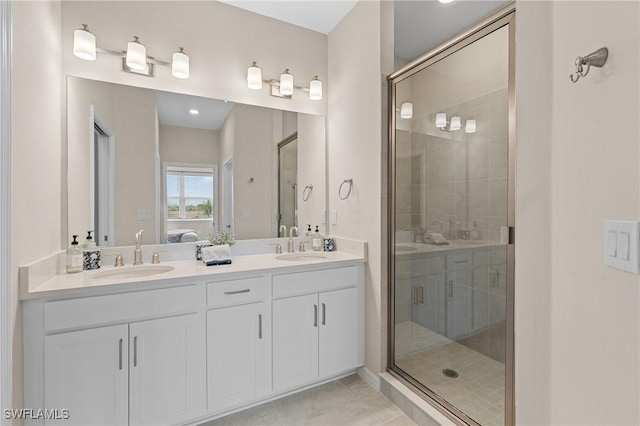 full bath with ensuite bathroom, a stall shower, tile patterned flooring, and a sink