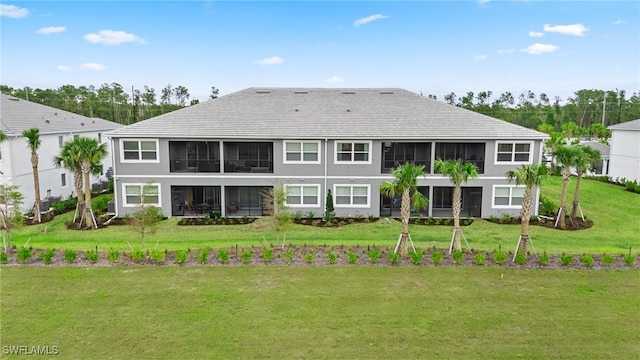 rear view of property with a yard