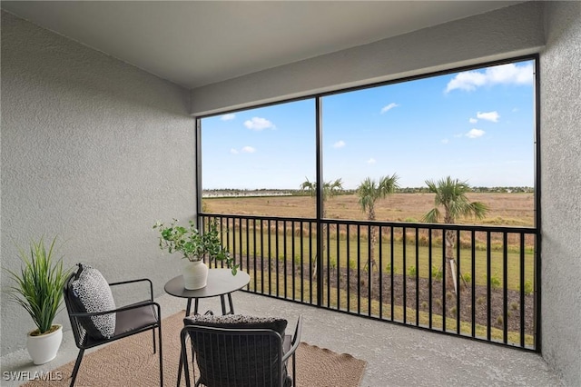 sunroom featuring a rural view