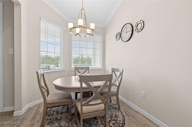 dining area with a notable chandelier, baseboards, crown molding, and wood finish floors