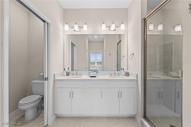 full bathroom with toilet, a shower stall, double vanity, and a sink