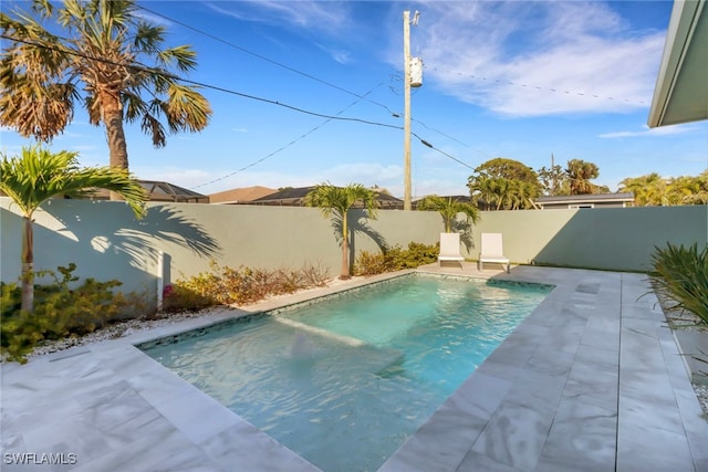 view of swimming pool with a patio, a fenced backyard, and a fenced in pool