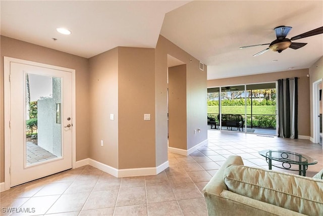 doorway featuring light tile patterned flooring, visible vents, and baseboards