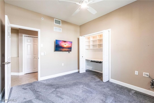 unfurnished bedroom with baseboards, visible vents, and dark colored carpet