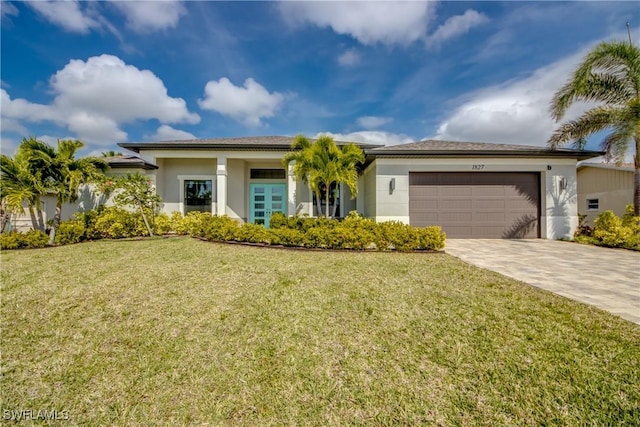 view of front of home featuring a garage, a front lawn, decorative driveway, and stucco siding