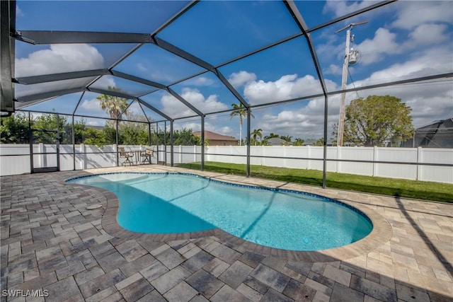 view of pool with a patio area, a fenced backyard, a fenced in pool, and glass enclosure