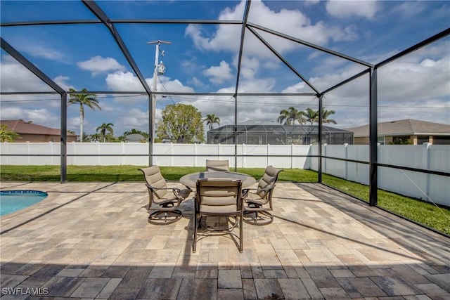view of patio with a fenced backyard, a fenced in pool, glass enclosure, and outdoor dining space