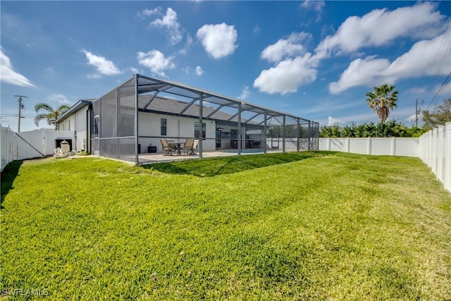 rear view of property featuring a patio area, a fenced backyard, and a yard