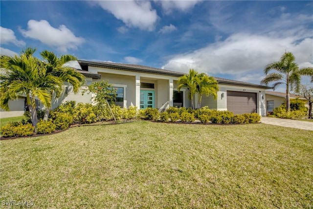 view of front of property with a garage, driveway, a front yard, and stucco siding