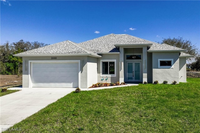 view of front facade with french doors, roof with shingles, concrete driveway, a garage, and a front lawn