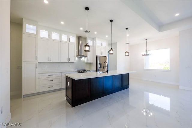 kitchen featuring light countertops, an island with sink, glass insert cabinets, and white cabinetry