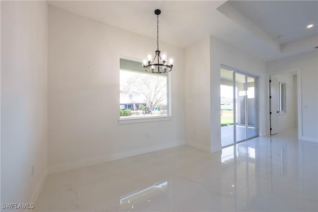 empty room with baseboards, marble finish floor, a tray ceiling, a notable chandelier, and recessed lighting