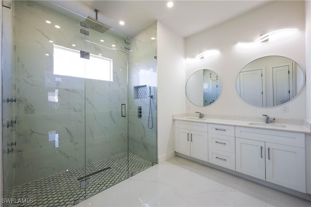 full bathroom featuring double vanity, marble finish floor, a marble finish shower, and a sink