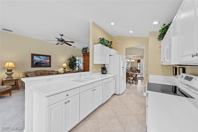 kitchen with white appliances, visible vents, white cabinets, open floor plan, and light countertops