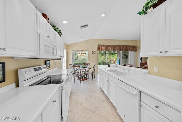 kitchen featuring light countertops, white appliances, a sink, and pendant lighting