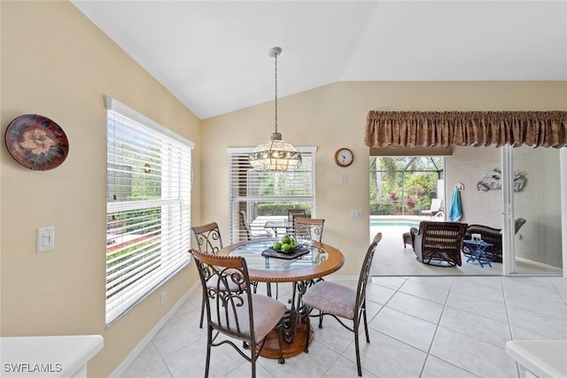 dining space featuring light tile patterned floors, baseboards, vaulted ceiling, and an inviting chandelier