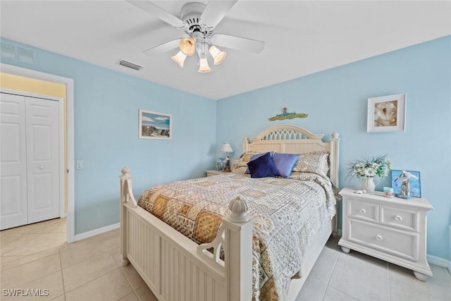 bedroom featuring light tile patterned floors, baseboards, visible vents, and a ceiling fan