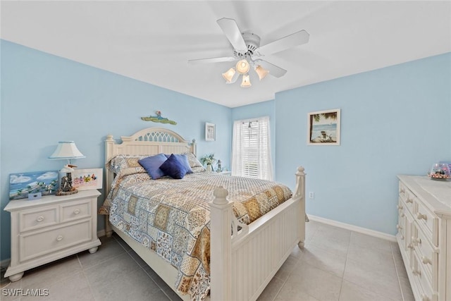 bedroom with light tile patterned floors, a ceiling fan, and baseboards