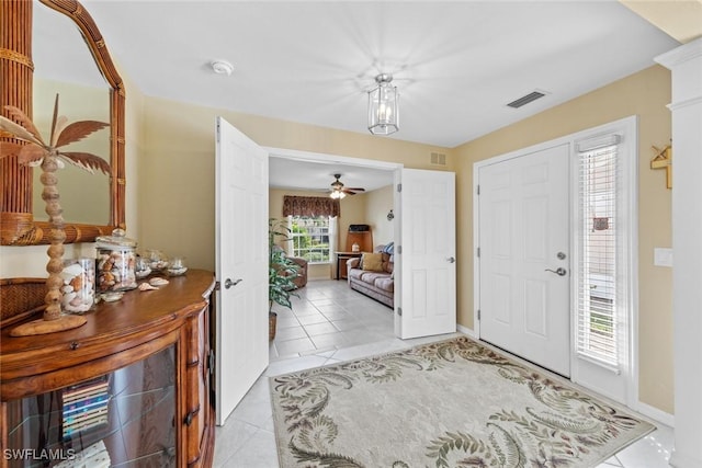 entryway with light tile patterned floors, visible vents, and baseboards