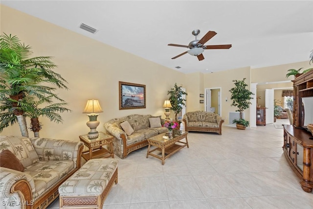 living room with visible vents, ceiling fan, and light tile patterned floors