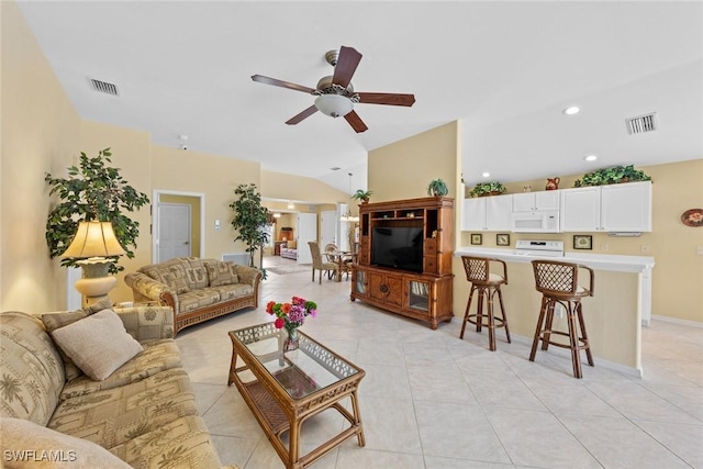 living room featuring light tile patterned floors, visible vents, and vaulted ceiling