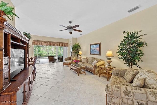 living room with light tile patterned floors, visible vents, and a ceiling fan